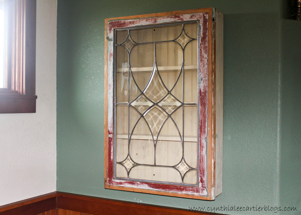 This is a picture of a wall cabinet made a vintage window
